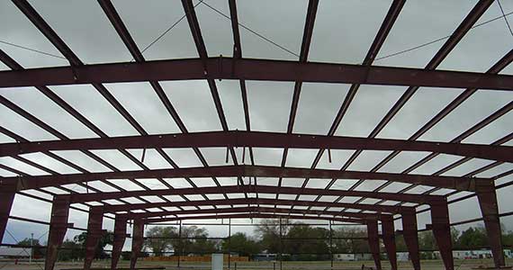 Red iron structural framing on an AMF steel building